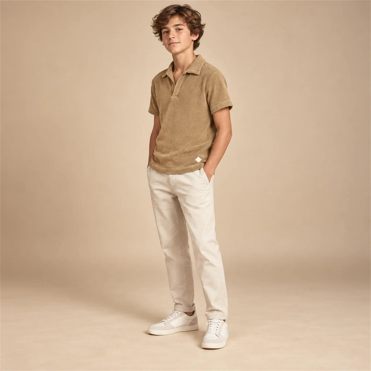 Beige studio lookbook: Boy Terry Knitted Polo Shirt - Brown; 14Y; full-body child model; look 1