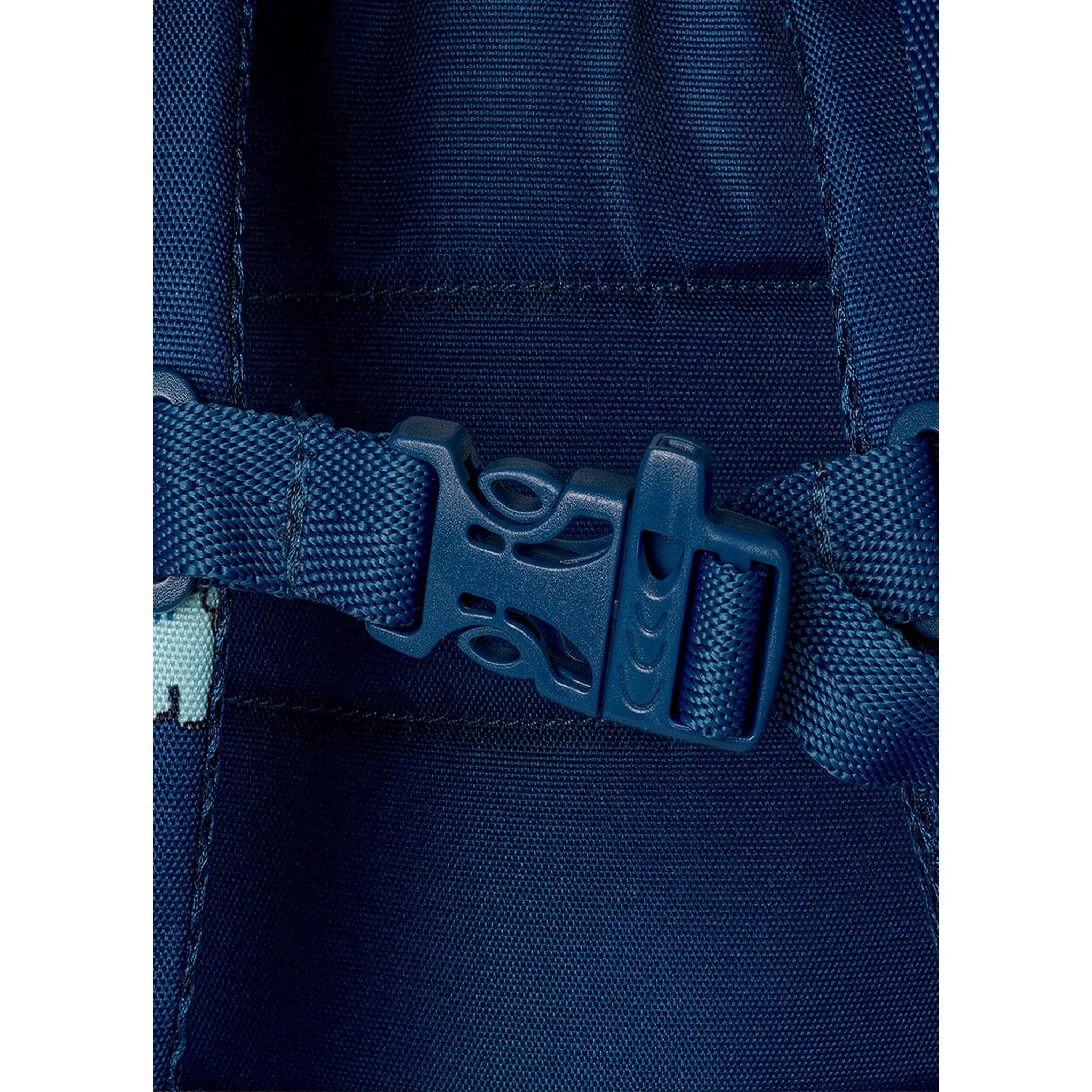 Close-up of the blue plastic chest strap buckle on a Lil Bunnies - The Collective medium dinosaur backpack
