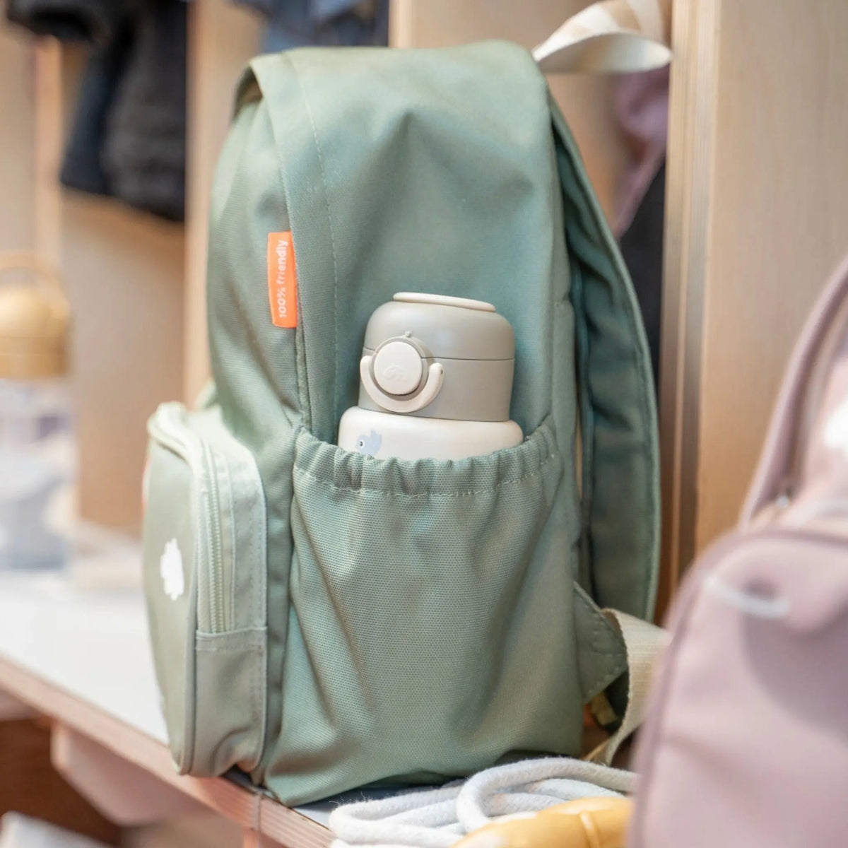 Lil Bunnies - The Collective sage green kids backpack with a side pocket holding a matching water bottle