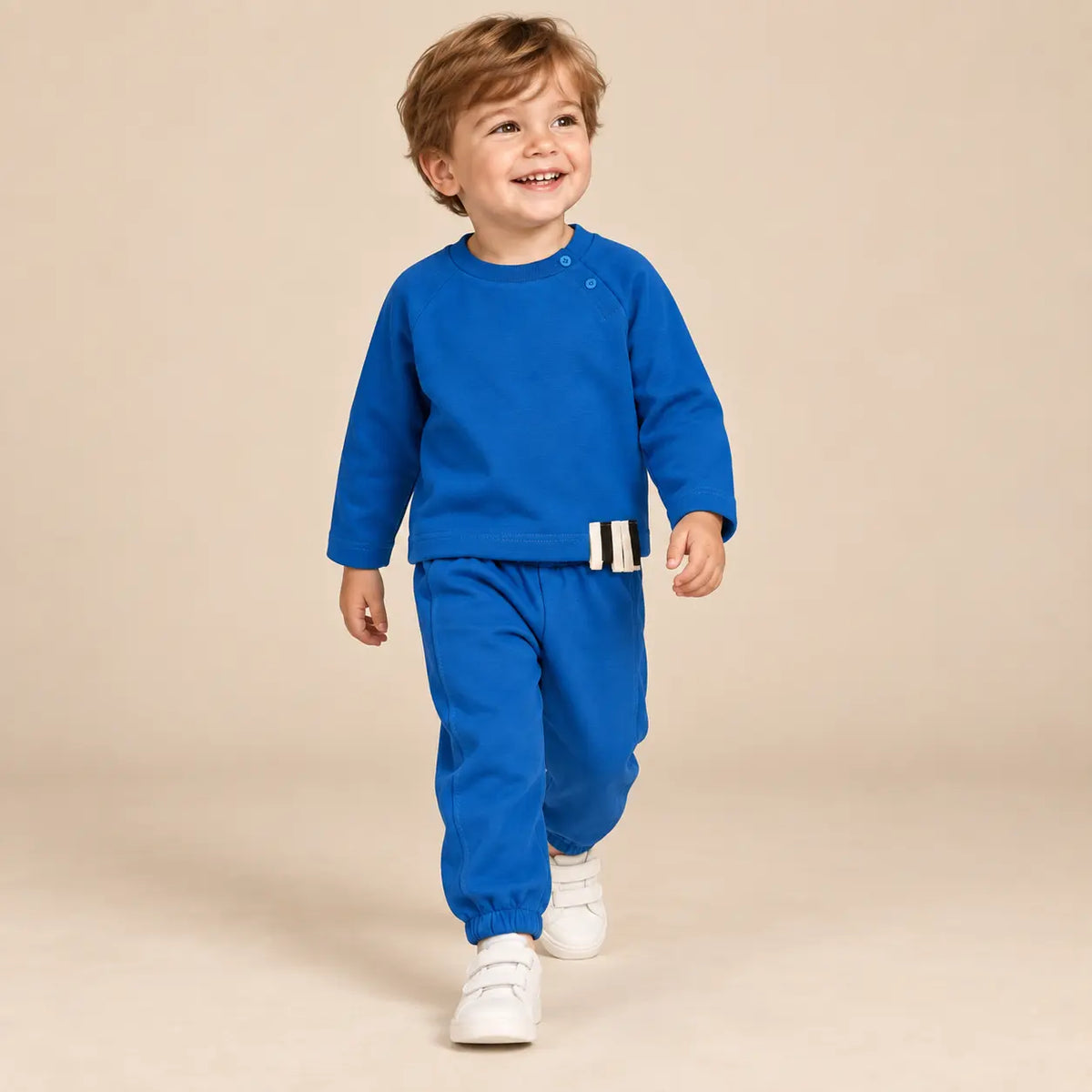 3 year boy wearing Blue Organic Cotton Sweatshirt &amp; Sweatpants walking pose