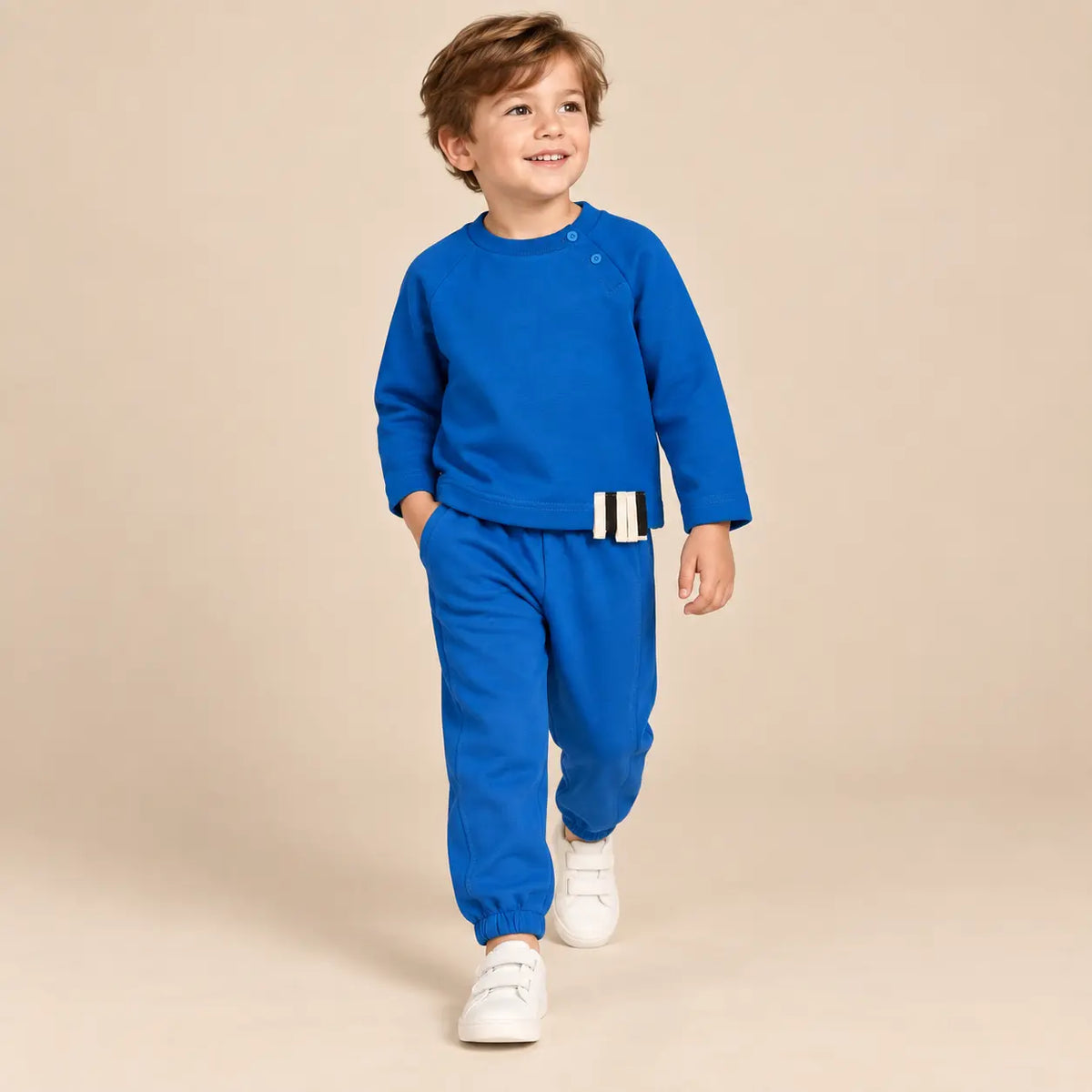 5 year boy wearing Blue Organic Cotton Sweatshirt &amp; Sweatpants walking pose