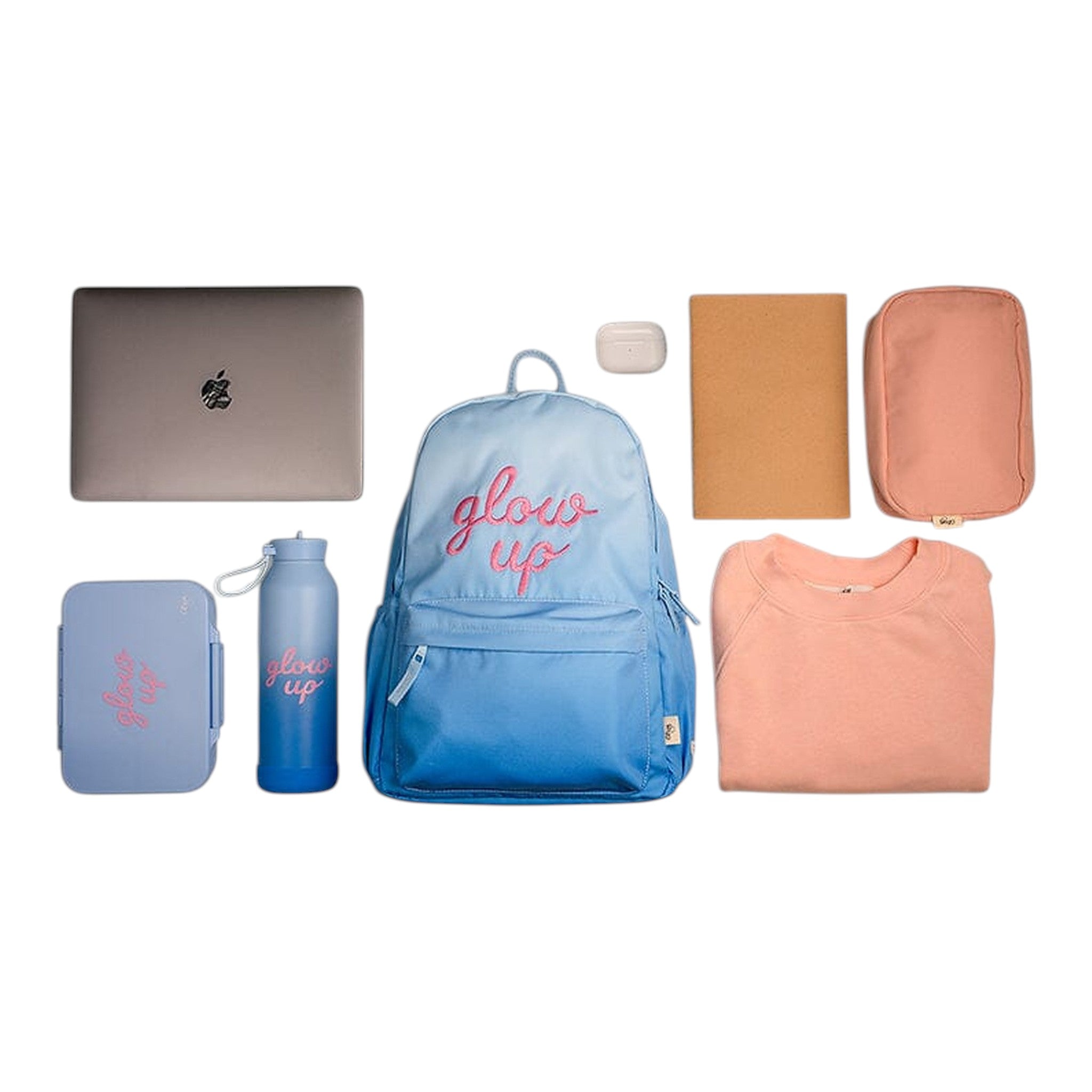 Lil Bunnies - The Collective blue ombre backpack with glow up embroidery surrounded by school essentials on white