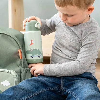 Lil Bunnies - The Collective green insulated bottle with a crocodile graphic held by a young boy next to a backpack