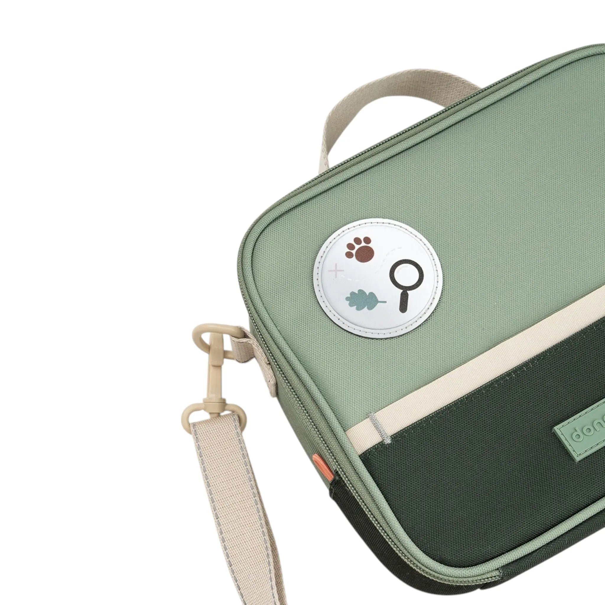 Lil Bunnies - The Collective insulated lunch bag in green with a nature-themed magnifying glass patch and strap.