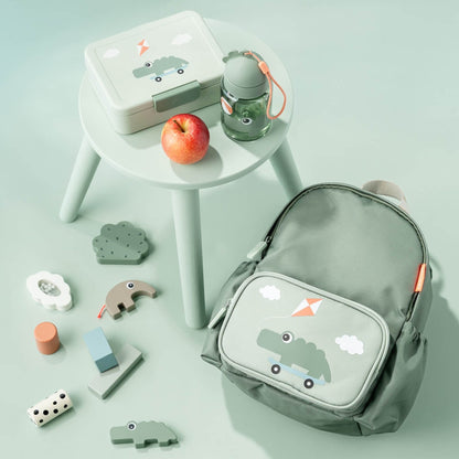 Lil Bunnies - The Collective green kids backpack with crocodile print next to a matching lunchbox and water bottle