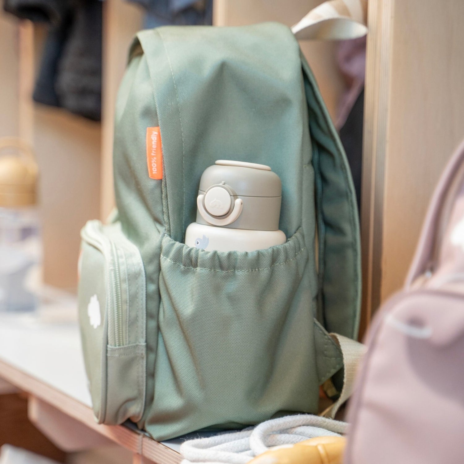 Lil Bunnies - The Collective sage green kids backpack with a side pocket holding a matching water bottle