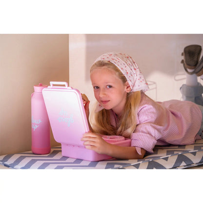 Young girl with a headscarf holding a Lil Bunnies - The Collective pink insulated lunchbox and matching food jar