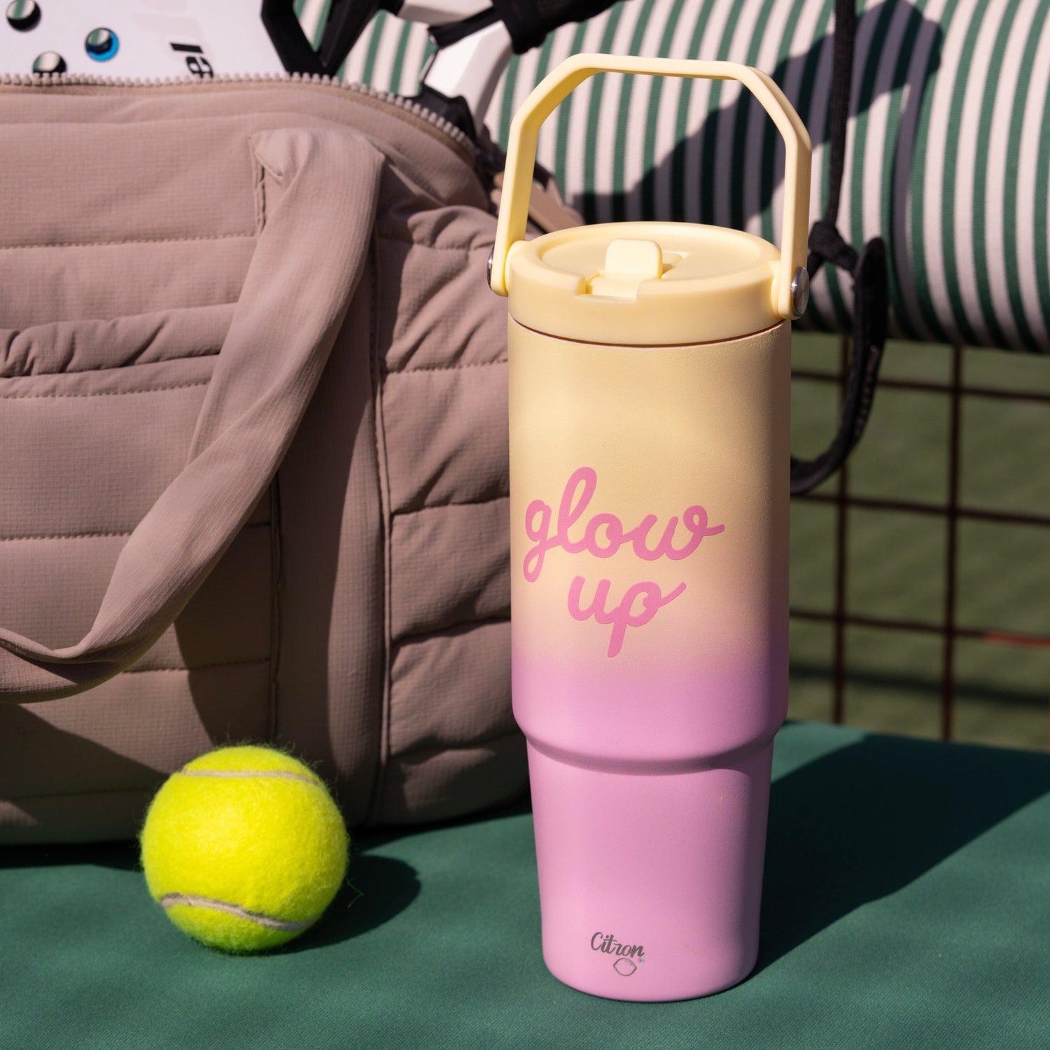 Lil Bunnies - The Collective 900ml insulated tumbler in pink and yellow ombre with glow up text on a tennis court