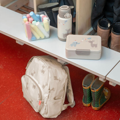 Lil Bunnies - The Collective sand-colored insulated bottle with cute animal print sitting on a shelf next to a lunchbox