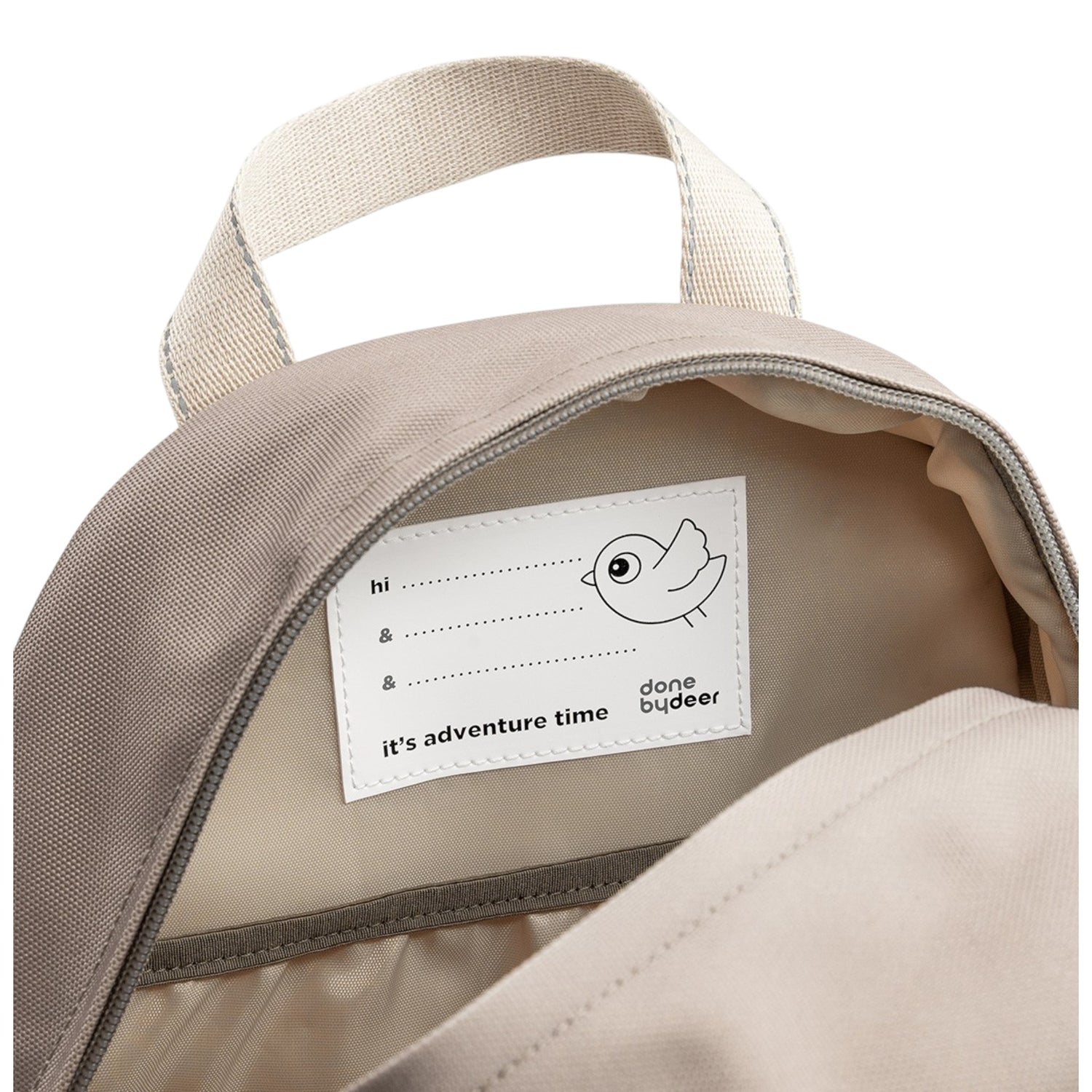 Lil Bunnies - The Collective Junior Backpack in sand showing the interior name tag label with bird illustration