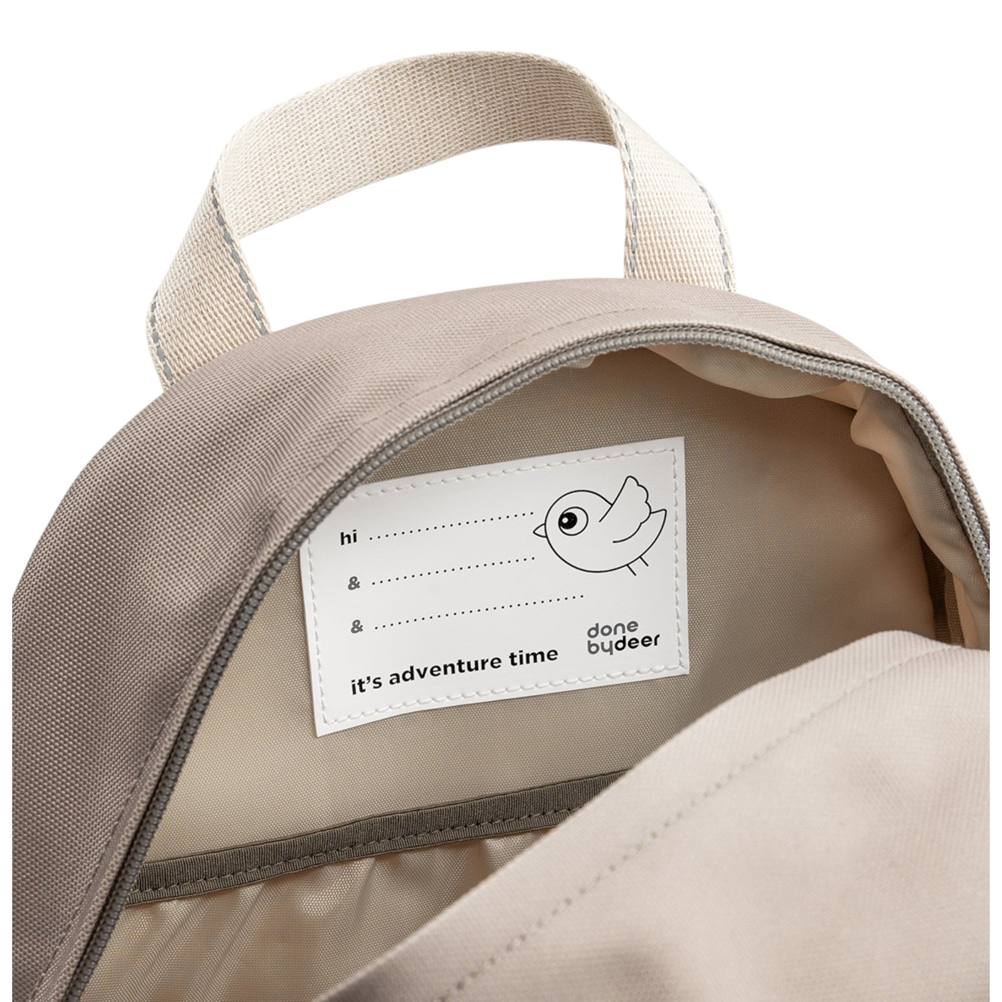 Lil Bunnies - The Collective Junior Backpack in sand showing the interior name tag label with bird illustration