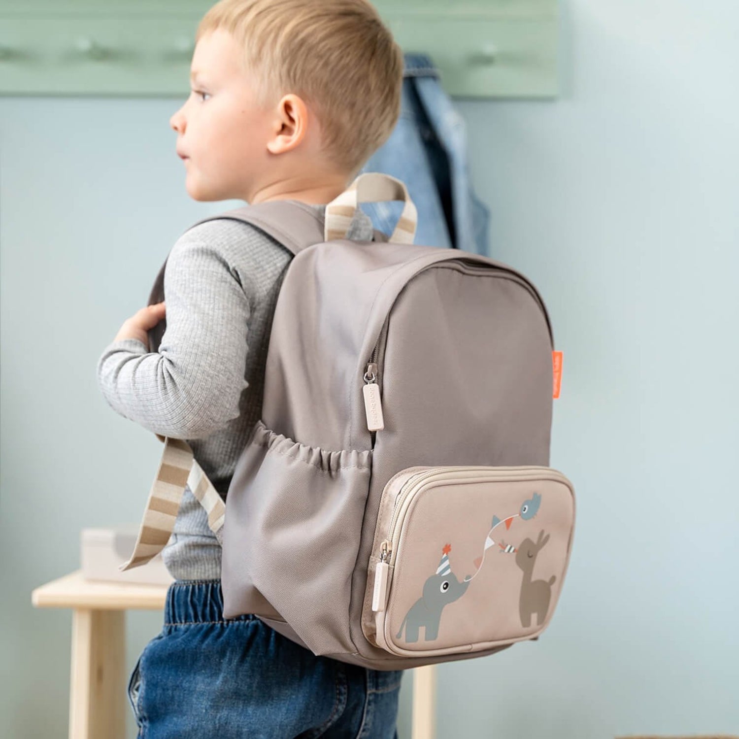 Lil Bunnies - The Collective sand-colored kids backpack with cute animal illustrations worn by a young boy