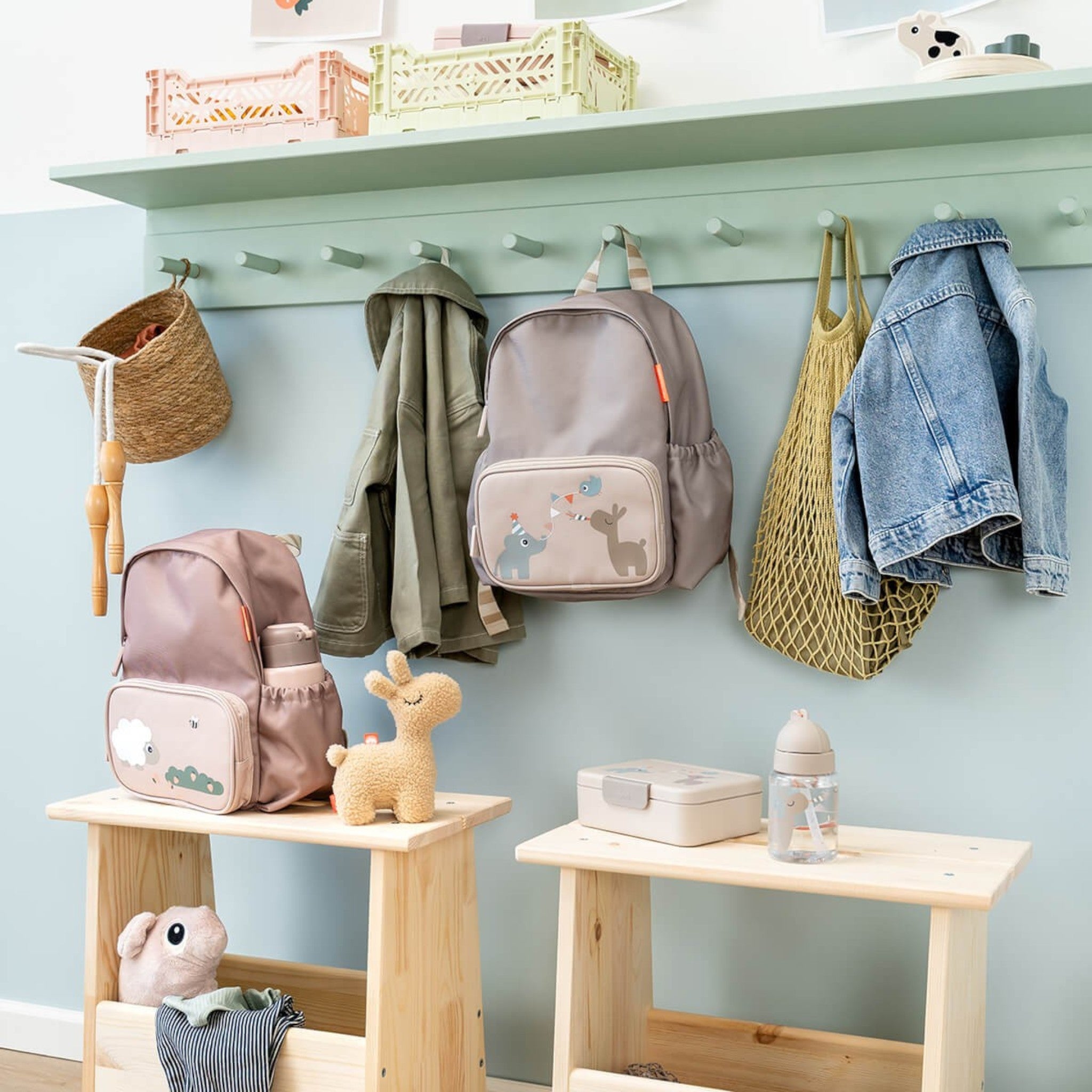 Lil Bunnies - The Collective kids backpack in sand colour with cute animal illustrations hanging on a wall hook