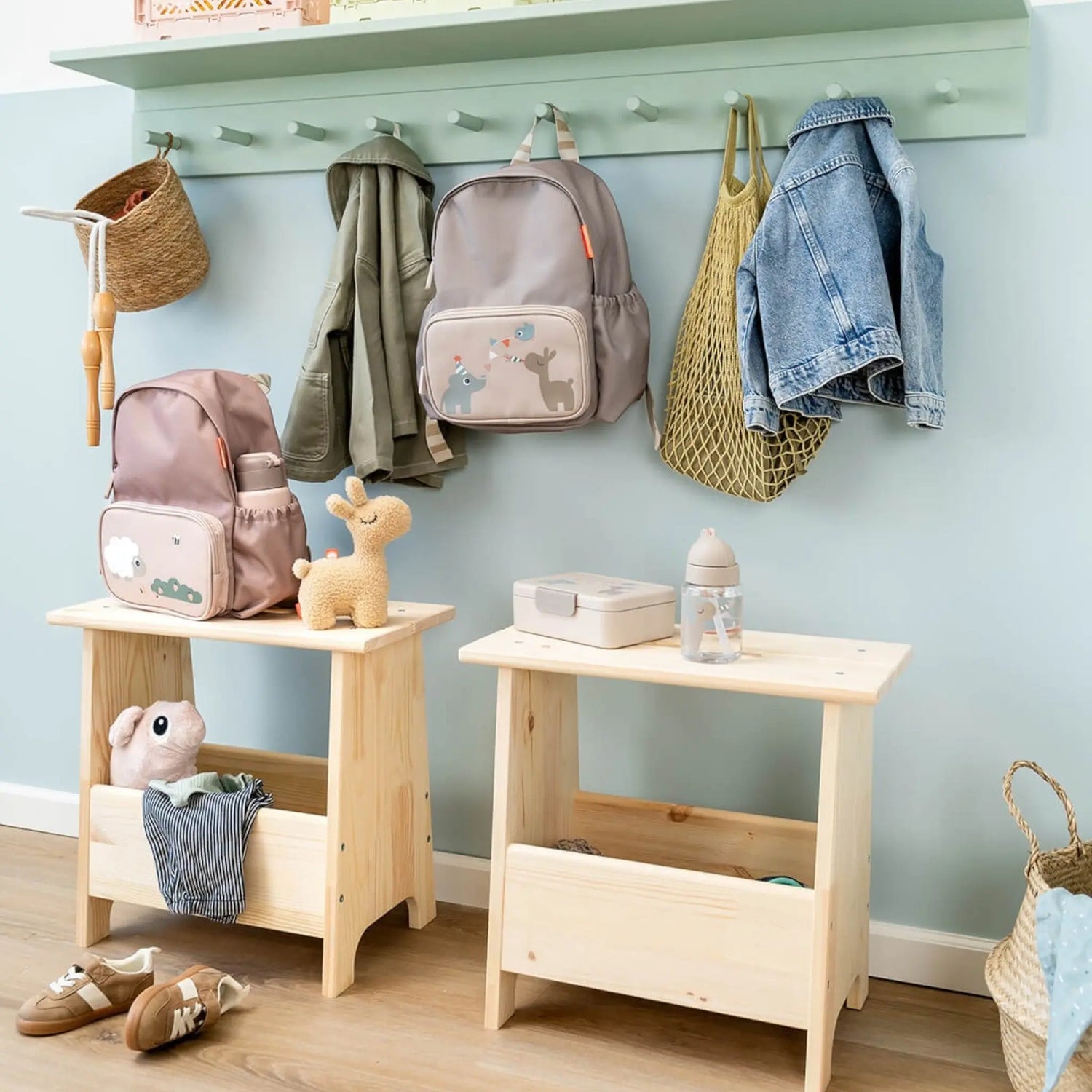 Lil Bunnies - The Collective sand-colored lunch box with divider sitting on a wooden stool in a nursery setting